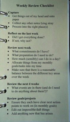 a notepad with the words weekly review checklist written in black ink on it