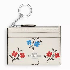 The Coach Women's Mini Skinny Top Zip ID Card Case with Floral Print is a compact and stylish way to carry your essentials. Made from refined pebble leather with a charming floral print, it features silver-tone hardware and a secure zip-top closure. This card case includes 2 credit card slots, an ID window, and an attached split key ring for added convenience. Its small size makes it perfect for slipping into your pocket or bag. Size: one size.  Color: White.  Gender: female.  Age Group: adult. Printed Leather, Floral Printed, Cloth Bags, Card Case, Pebbled Leather, Chalk, Women's Accessories, Bag Accessories, Floral Print