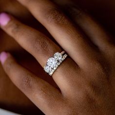 a woman's hand with two diamond rings on it