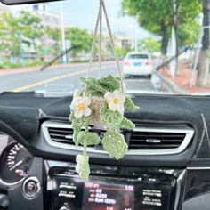 the interior of a car with flowers hanging from it's dash board and dashboard