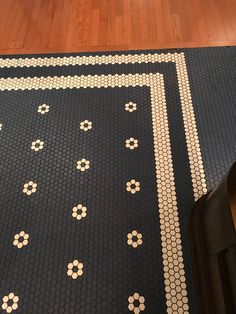 a black rug with white and gold designs on it