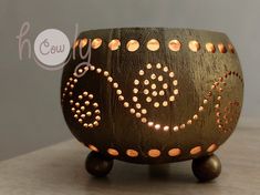 a small wooden bowl with dots on it