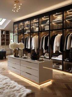 a large walk in closet with lots of clothes