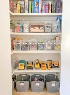 the shelves are filled with various toys and storage bins for children's books