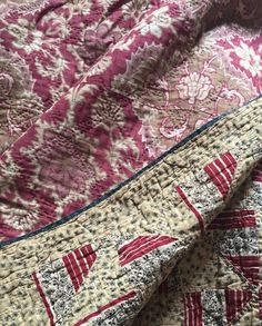 two quilts are laying next to each other on a bed sheet that has red and white designs