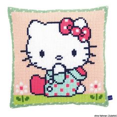 a cross stitch pillow with a hello kitty on it