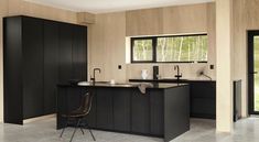 a large kitchen with black cabinets and an island