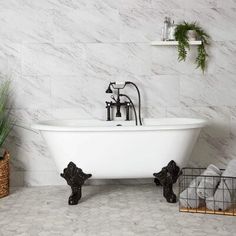 a white bath tub sitting in a bathroom next to a plant and toilet paper dispenser