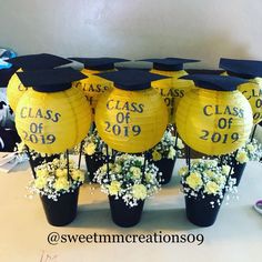 graduation decorations with yellow flowers and black vases