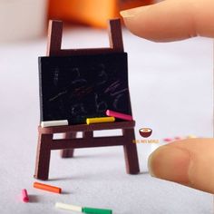 a miniature easel with colored crayons on it