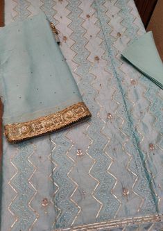 Item Overview ATHARVA Hand Embroidered Salwar Kameez in Blue w/Thread Jaal/ Elegant Hand Work/Gota Patti Border Dupatta/Customized Stitching/Wedding Dno. CH1249 Fabric:  * Shirt Chanderi 2.5 Mts, Blue Jaal Embroidery  * Dupatta: Pure Chiffon Chinnon Dupatta with Gota Patti work 2.5 Mts. * Bottom Santoon Silk 2.5 Mts. Excusive Hand Embroidered Party Wear Punjabi Suit. 🌷CUSTOMIZATION (No Extra Charges) * Fabrics Customization: Designs Can be made in different Fabrics. *Color Customization: Design Jaal Embroidery, Patiala Salwar Kameez, Embroidery Dupatta, Embroidered Salwar, Patiala Salwar, Embroidered Pants, Pure Chiffon, Punjabi Suit, Punjabi Suits