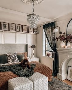 a bed room with a neatly made bed and a large mirror above the headboard