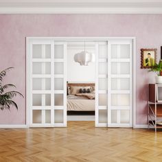 an empty room with pink walls and white glass doors that lead to a bed in the corner