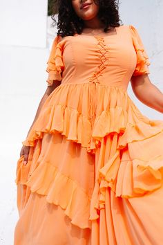 The Solana Dress in Apricot is a stunning piece that will elevate any wardrobe. Its unique features, including a square neckline, flutter sleeves, & a ruffle tiered skirt with pockets, make it both fashionable and functional. The hidden back zipper and functional front corset add a touch of elegance. With a non-stretch fabric and a lined bodice and skirt, this dress offers both comfort and style. Billowy Tiered Summer Dress, Flowy Tiered Midi Dress With Ruffles, Short Sleeve Dress With Ruffles And Flowy Skirt, Flowy Skirt Dress With Ruffles And Short Sleeves, Flowy Tiered Ruffle Midi Dress, Tiered Midi Dress With Ruffles And Flowy Skirt, Flowy Midi Dress With Ruffles, Flowy Square Neck Midi Dress With Ruffles, Fitted Tiered Dress With Flutter Sleeves And Ruffle Hem