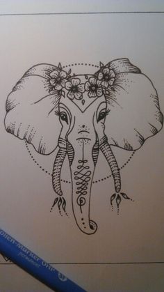 an elephant's head with flowers on its tusks is drawn in pencil