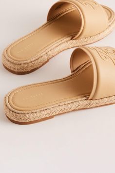 Crafted from sumptuous 100% sheep leather for a luxurious feel
Slip-on slide design with open toe for effortless wear
Embossed Ted Baker branding adorns the vamp for a signature touch
Espadrille-inspired woven midsole adds textural interest
Cushioned footbed ensures all-day comfort
Effortlessly chic, these leather slides from Ted Baker are the perfect choice for casual weekend outings or relaxed family gatherings. Pair them with breezy dresses or tailored shorts and a camisole for a laidback yet polished look that exudes understated elegance. Their versatile design allows you to transition seamlessly from day to night with a simple change of accessories. Holiday Outfits Summer, Holiday Outfits Women, Shoe Crafts, Breezy Dress, Oasis Fashion, Tailored Shorts, Casual Weekend, Sheep Leather, Puff Sleeve Dresses