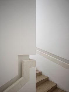 the stairs are made of wood and white paint