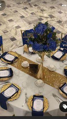 the table is set with blue and gold place settings