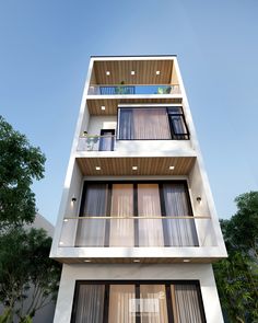 a tall white building with lots of windows and balconies on the top floor