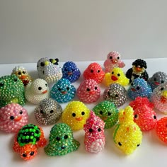 there are many small beads that look like birds on the counter top, and one is made out of glass beads