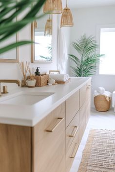 a bathroom with white counter tops and wooden cabinets