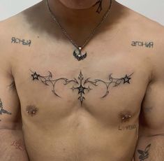 a man with tattoos on his chest has an arrow and stars tattoo on his chest