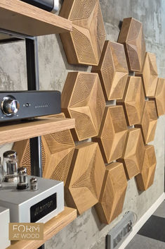 the wall is made out of wood and has speakers on each side, along with other items