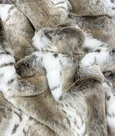 an animal print fabric with white and grey fur