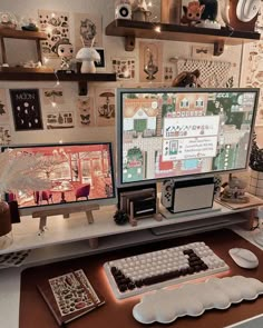 two computer monitors sitting on top of a desk next to a keyboard and monitor screen