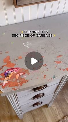 a piece of garbage sitting on top of a white dresser next to a wall with the words flipping this $ 50 piece of garbage