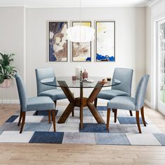 a glass table with four blue chairs in front of two pictures hanging on the wall