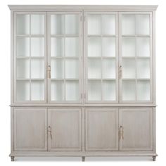 a white bookcase with glass doors on the top and bottom shelves, in front of a white background