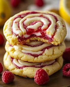 raspberry swirl cookies stacked on top of each other with fresh raspberries