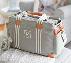 a gray and white bag sitting on top of a couch