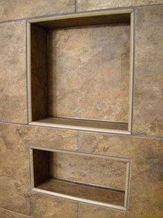 an empty shelf in the middle of a tiled wall