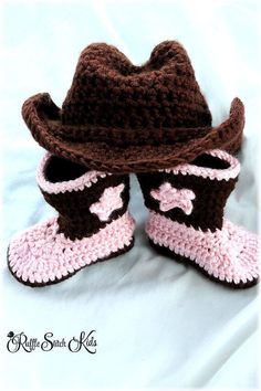 a pair of crocheted baby booties with a cowboy hat