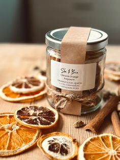 an orange cut in half sitting on top of a table next to cinnamons and spices