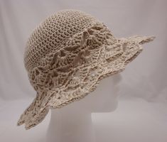 Crocheted wide brim sun hat to keep the damaging UV rays off the face. Beautiful open-work design on brim and part of body of hat. Beige in color. Sized for average women's head size.   Made with mercerized Egyptian cotton which is the finest cotton you can lay your hands on! Mercerized cotton has a gentle sparkle when knitted or crocheted and contains long fibers, making it extremely strong, wearable and durable. Pattern is based on a Drop's design.  Sized to fit average women's head size: 22 1 Bohemian Brimmed Cream Sun Hat, Cream Brimmed Crochet Hat For Summer, Summer Brimmed Crochet Hat In Cream, Summer Cream Brimmed Crochet Hat, Cream Brimmed Crochet Beach Hat, Cream Brimmed Crochet Hat For Beach, Beige Wide Brim Crochet Hat, Adjustable Wide Brim Crochet Hat In Cream, Adjustable Wide Brim Cream Crochet Hat