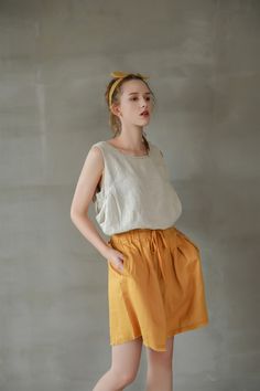 "Stunning colors, relaxed fit, and breathable pure linen fabric, are all you need for a pair of shorts in hot summer days, and even edgier look with the unfinished hem. - 100% Linen - High rise - Elastic band with drawstring to tie up - 2 side pockets - Unfinished hem details - Listing colors: Taupe, Cloudy Sky, Bright Yellow, White, and Black. - Matching top available: https://www.etsy.com/listing/962043184/loose-linen-tank-top-causal-linen-tank?ref=shop_home_active_4&frs=1&crt=1 Please Beige Cotton Shorts Solid Color, Loosely Fitted High Waist Shorts For Summer, Beige Shorts For Summer, Solid Knee-length Summer Shorts, Relaxed Fit Solid Color Shorts For Summer, Summer Elastic Waistband Flax Bottoms, Summer Bottoms With Elastic Waistband In Beige, Summer Bottoms With Elastic Waistband In Flax Color, Beach Linen Bottoms Solid Color