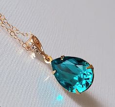 Indicolite Dark Teal Crystal Gold Teardrop Wedding Pendant Necklace with 14k Gold Filled Chain. PLEASE READ ITEM DESCRIPTION before placing your order, and contact me with any questions! CHAIN is 18 inches (45.7cm) long, PENDANT is about 1 inch (2.5cm) long including bail. NECKLACES SECTION: https://www.etsy.com/shop/LanaChayka?ref=seller-platform-mcnav§ion_id=17026331 BRIDAL NECKLACES SECTION: https://www.etsy.com/shop/LanaChayka?ref=seller-platform-mcnav§ion_id=11638944 Elegant and timeless, t Dark Teal Wedding, Dark Teal Weddings, Teal Jewelry, Crystal Wedding Necklace, Teal Necklace, Gold Crystal Necklace, Bridal Necklaces, Wedding Pendant, Teal Wedding