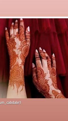 two hands with henna tattoos on them