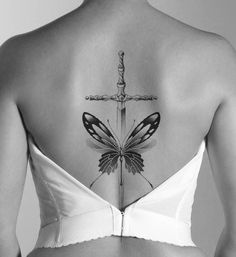 the back of a woman's bra with a butterfly tattoo on her upper part