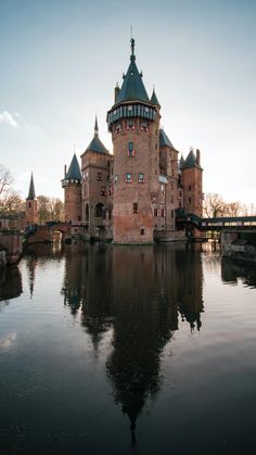 an old castle is reflected in the water