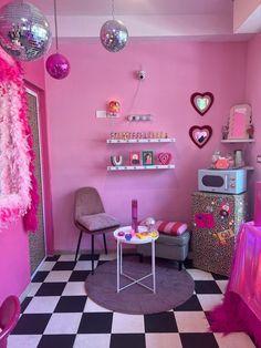 a room with pink walls and black and white checkered floor