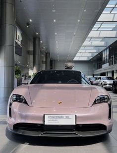 a pink sports car is parked in a building