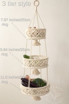 three tiered macrame plant hanger with plants in it