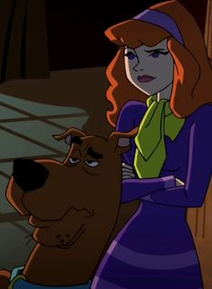 a woman in a purple dress standing next to a dog with her hand on the nose