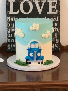 a blue and white cake sitting on top of a wooden table