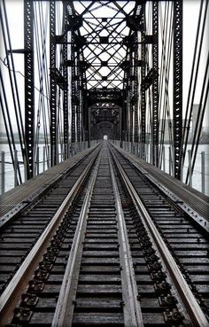 an old train track going across the bridge