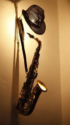 a saxophone hanging on the wall next to a lamp